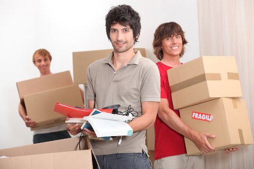 Staff carrying boxes safely as part of a professional removals service
