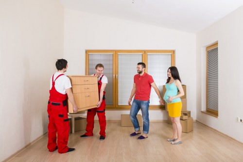 Packed boxes and furniture being loaded into a removal van