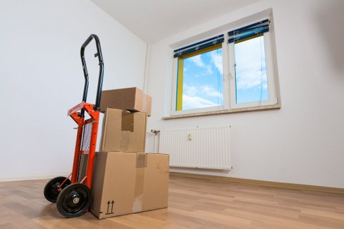 Removal team carrying items from a Brixton flat with stairs